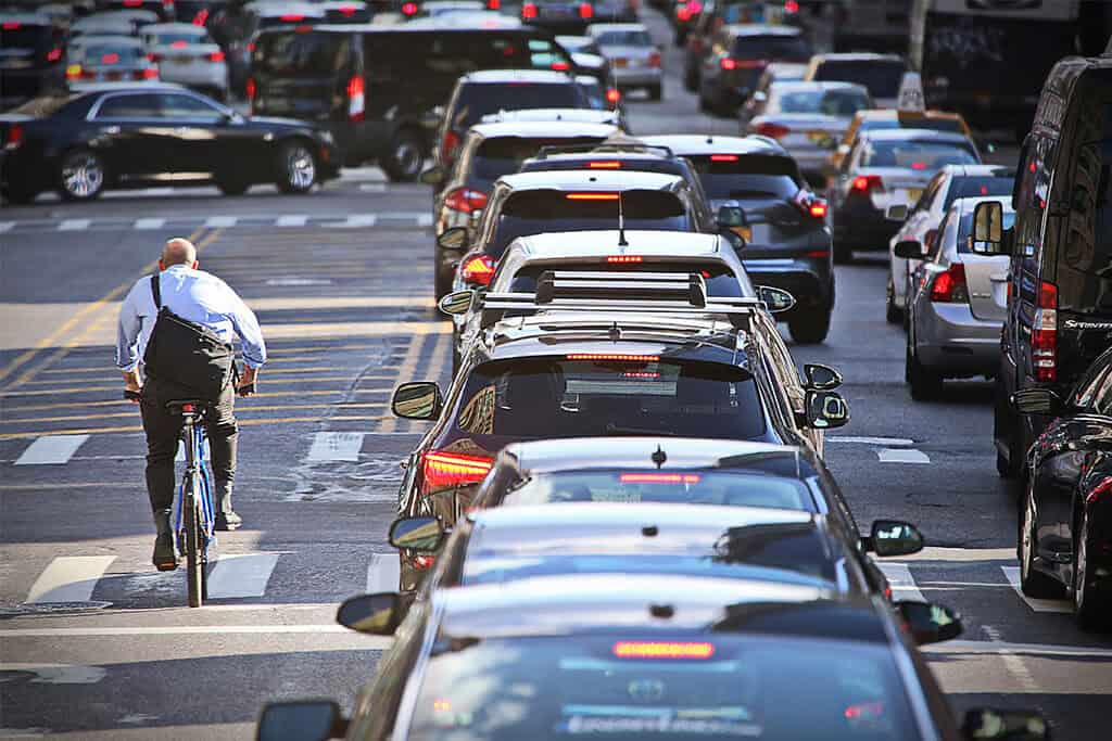 Traffic jam congestion and a cyclist.